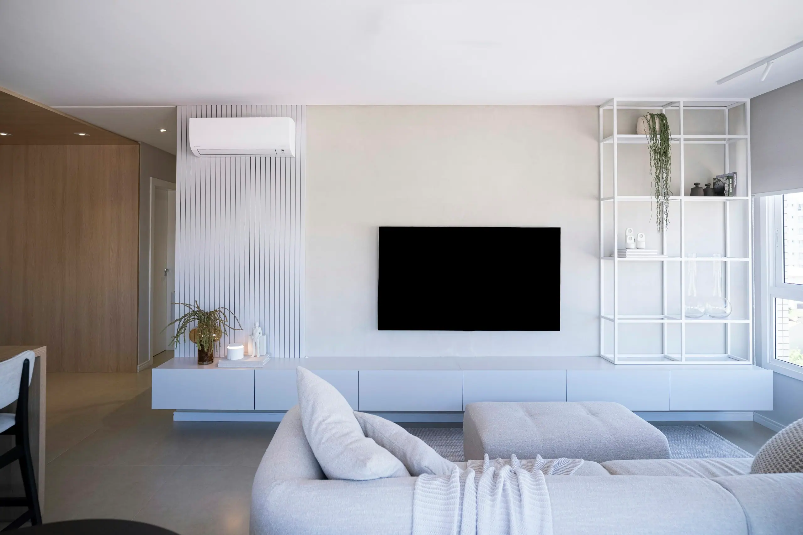 Bright modern living room with a discreet wall-mounted air conditioning unit