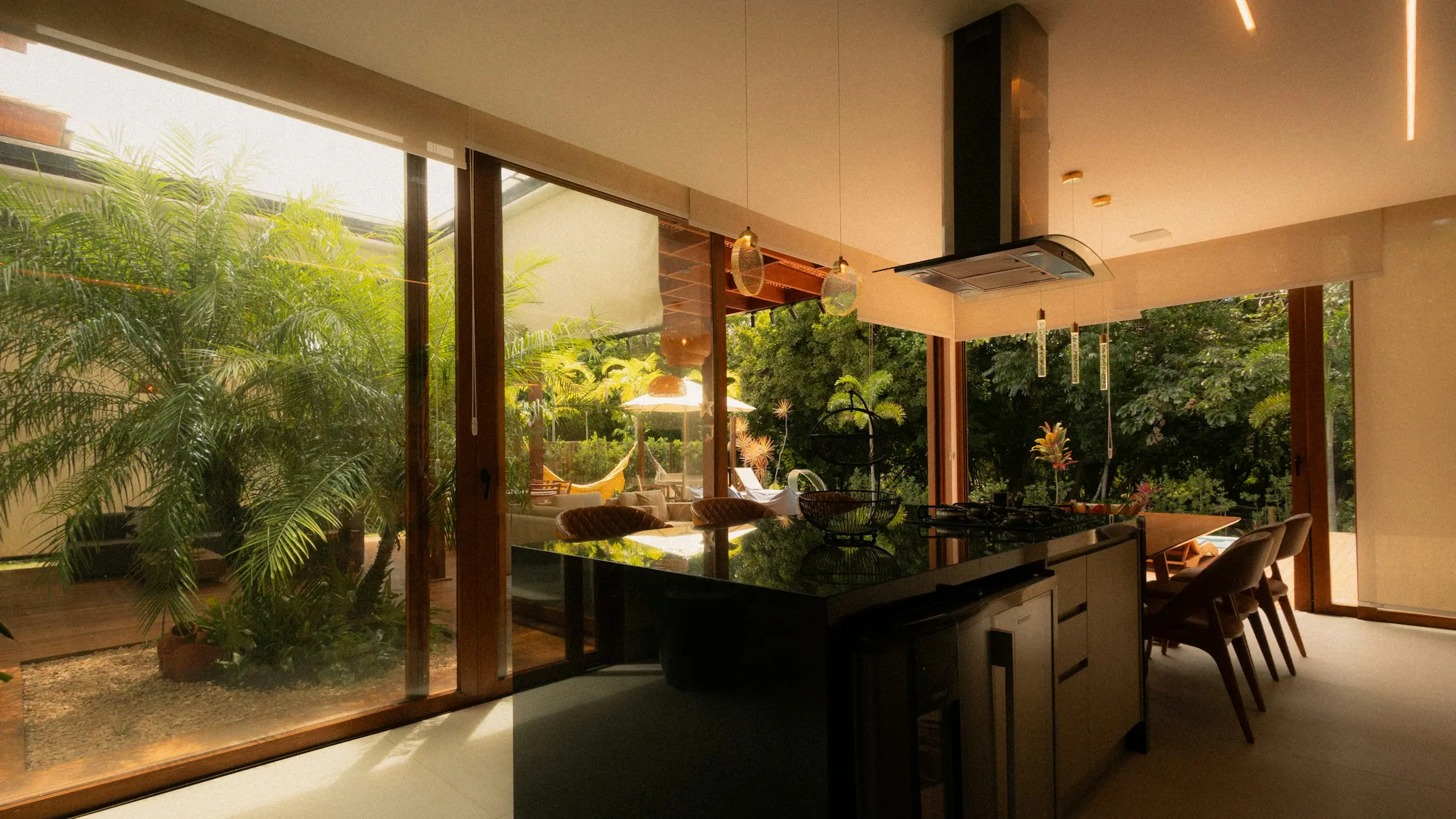 Kitchen extension at golden hour looking out to a leafy garden