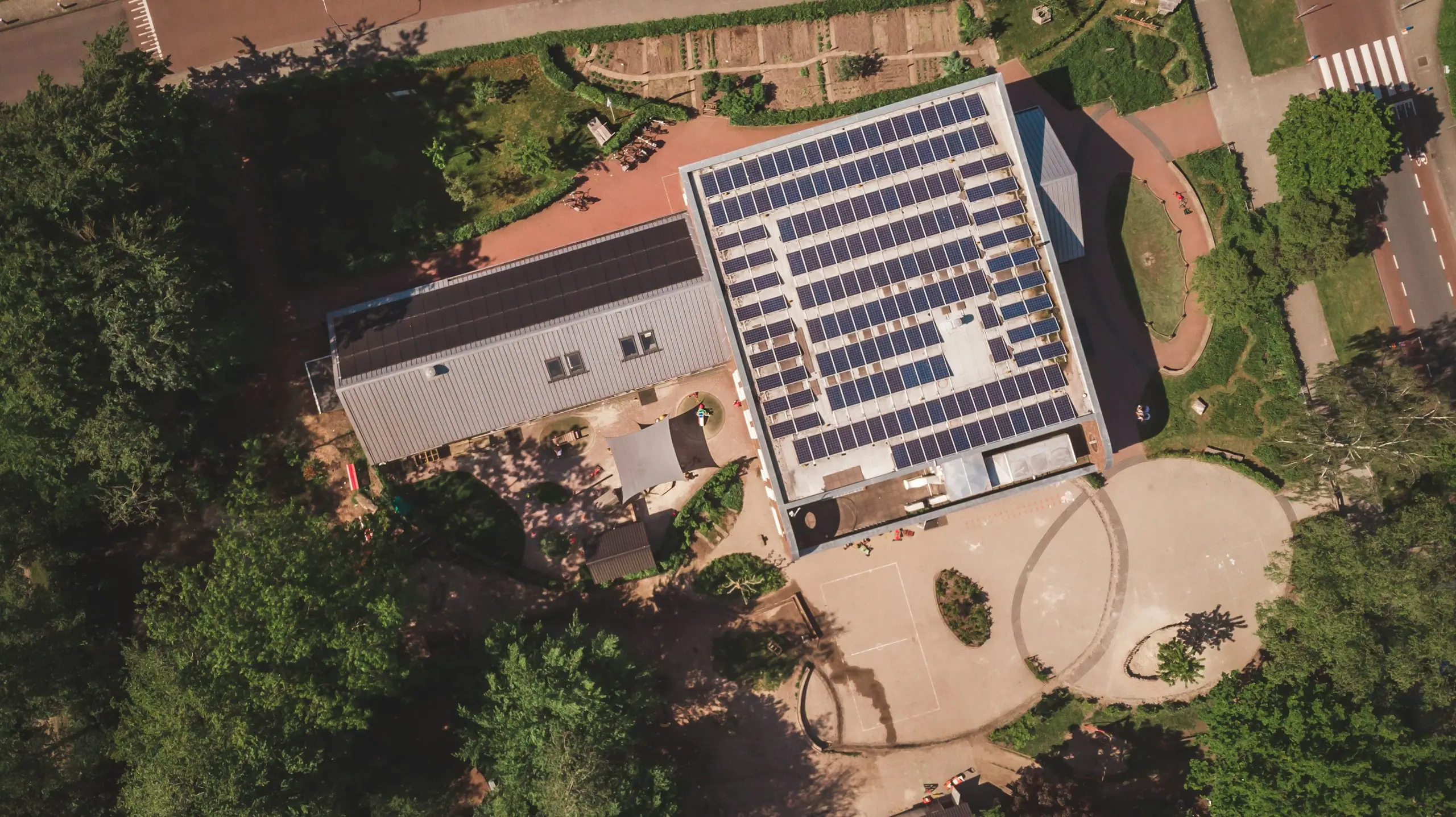 Aerial view of a commercial building with a rooftop solar array